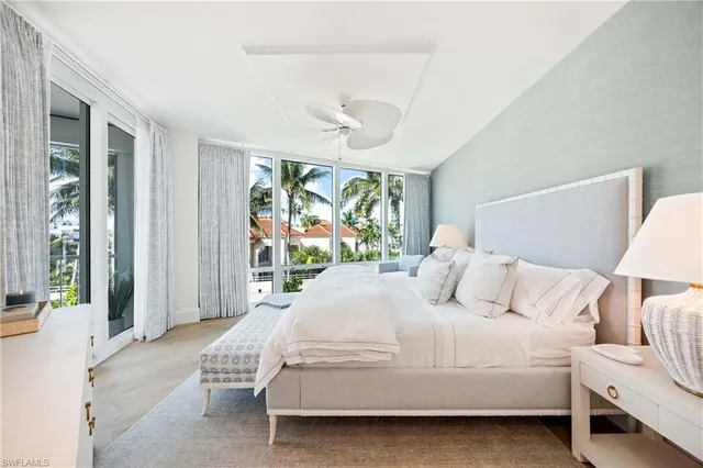 a bedroom with a large bed and a large window