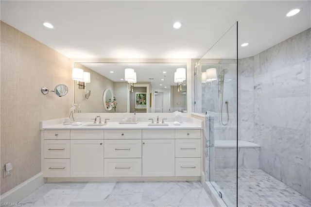 a bathroom with a granite countertop sink mirror and double