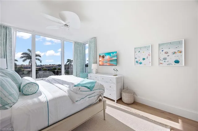 a bedroom with a bed and a large window