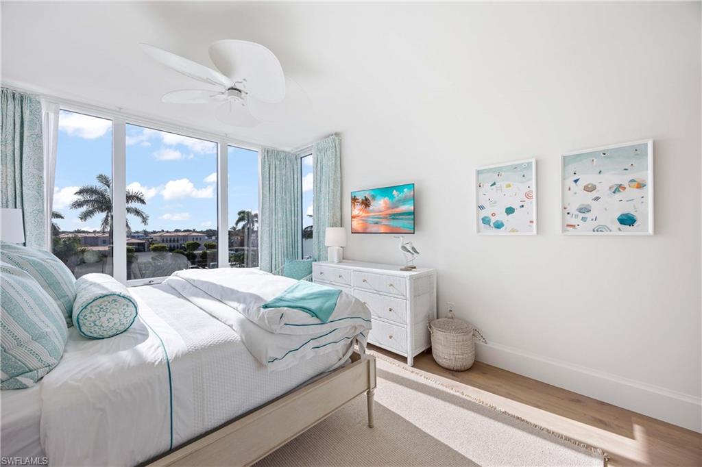 3971 Gulf Shore Boulevard North, Unit 401 Naples, FL 34103 - Photo 30 of 50 a bedroom with a bed and a large window