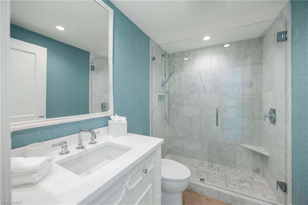 3971 Gulf Shore Boulevard North, Unit 401 Naples, FL 34103 - Photo 31 of 50 a bathroom with a sink a toilet and shower