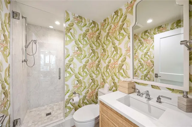 a bathroom with a sink a toilet and shower