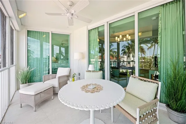 a living room with furniture a large window and a table