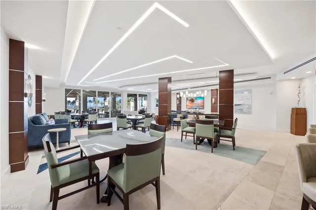 a dining room with wooden floor a table and chairs