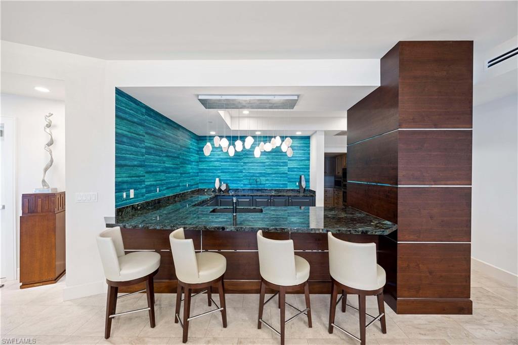 3971 Gulf Shore Boulevard North, Unit 401 Naples, FL 34103 - Photo 41 of 50 a bathroom with a toilet and a sink