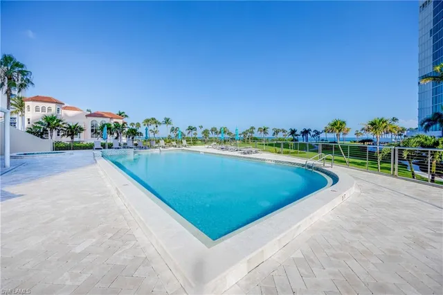 a view of a swimming pool with a yard