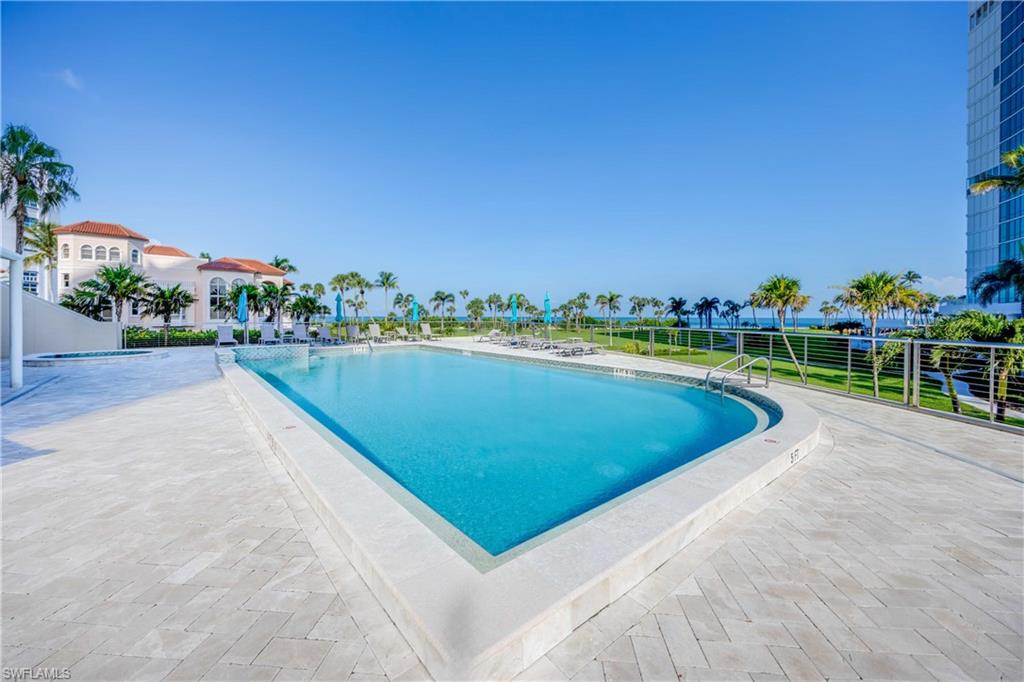 3971 Gulf Shore Boulevard North, Unit 401 Naples, FL 34103 - Photo 44 of 50 a view of a swimming pool and a yard
