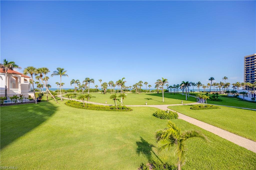 3971 Gulf Shore Boulevard North, Unit 401 Naples, FL 34103 - Photo 45 of 50 a view of a swimming pool with a yard