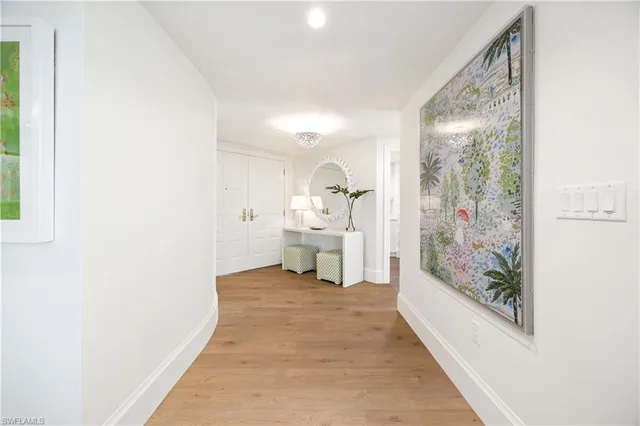 a view of a room with wooden floor and a bathroom