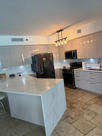 a kitchen with cabinets appliances and a counter top