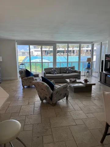 a living room with furniture and a large window