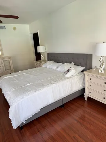 a view of a hallway with wooden floor and stairs