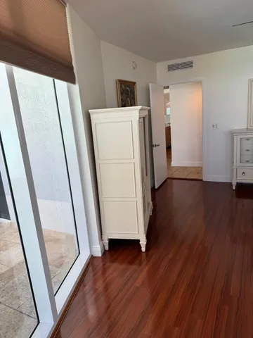 a view of a livingroom with wooden floor and chair
