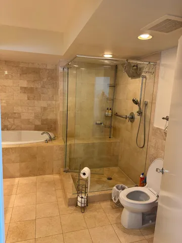 a bathroom with a toilet and a mirror