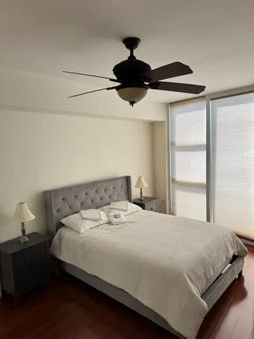 a large bed sitting in a bedroom next to a window