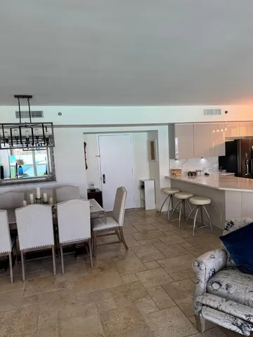 a view of a dining room with furniture and a kitchen