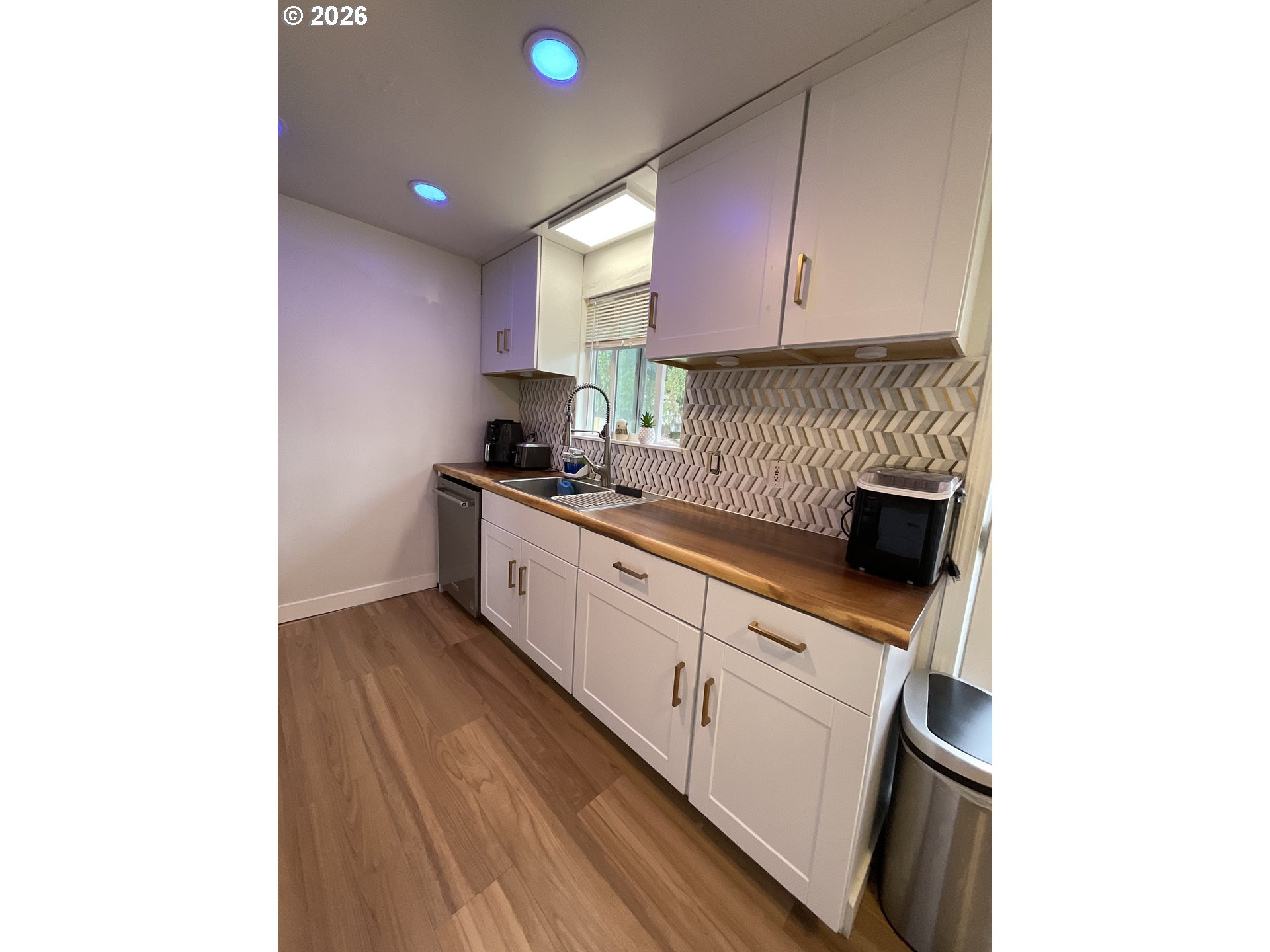 19305 Southwest York Street Beaverton, OR 97003 - Photo 11 of 34 a kitchen with a sink cabinets and a window