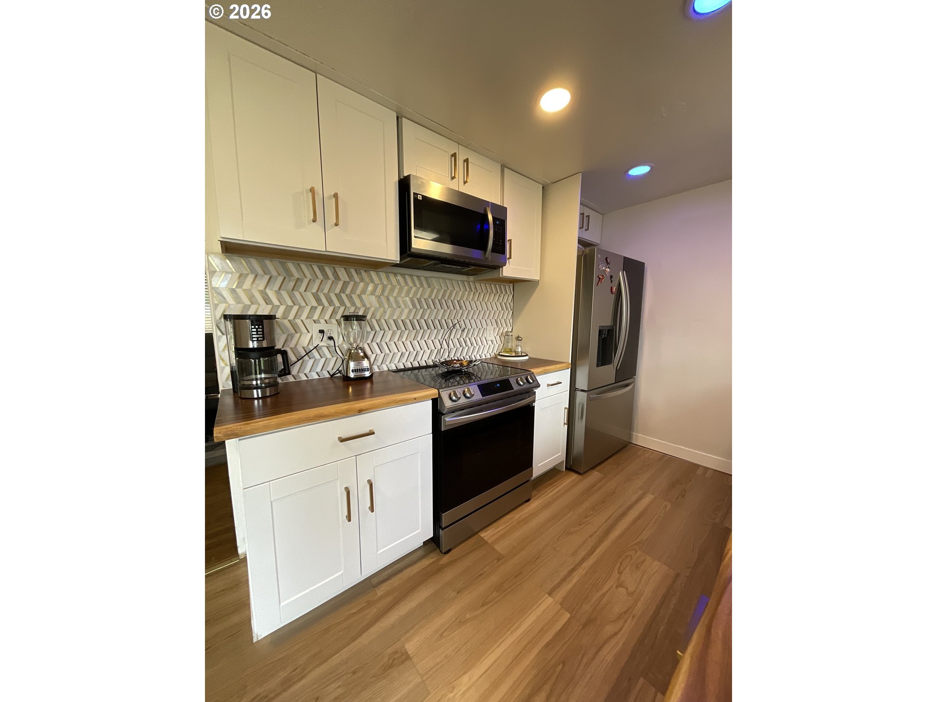 19305 Southwest York Street Beaverton, OR 97003 - Photo 13 of 34 a kitchen with stainless steel appliances granite countertop a stove a sink and a refrigerator