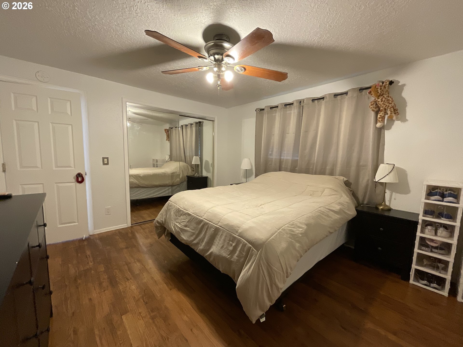 19305 Southwest York Street Beaverton, OR 97003 - Photo 17 of 34 a bedroom with a bed and a chandelier
