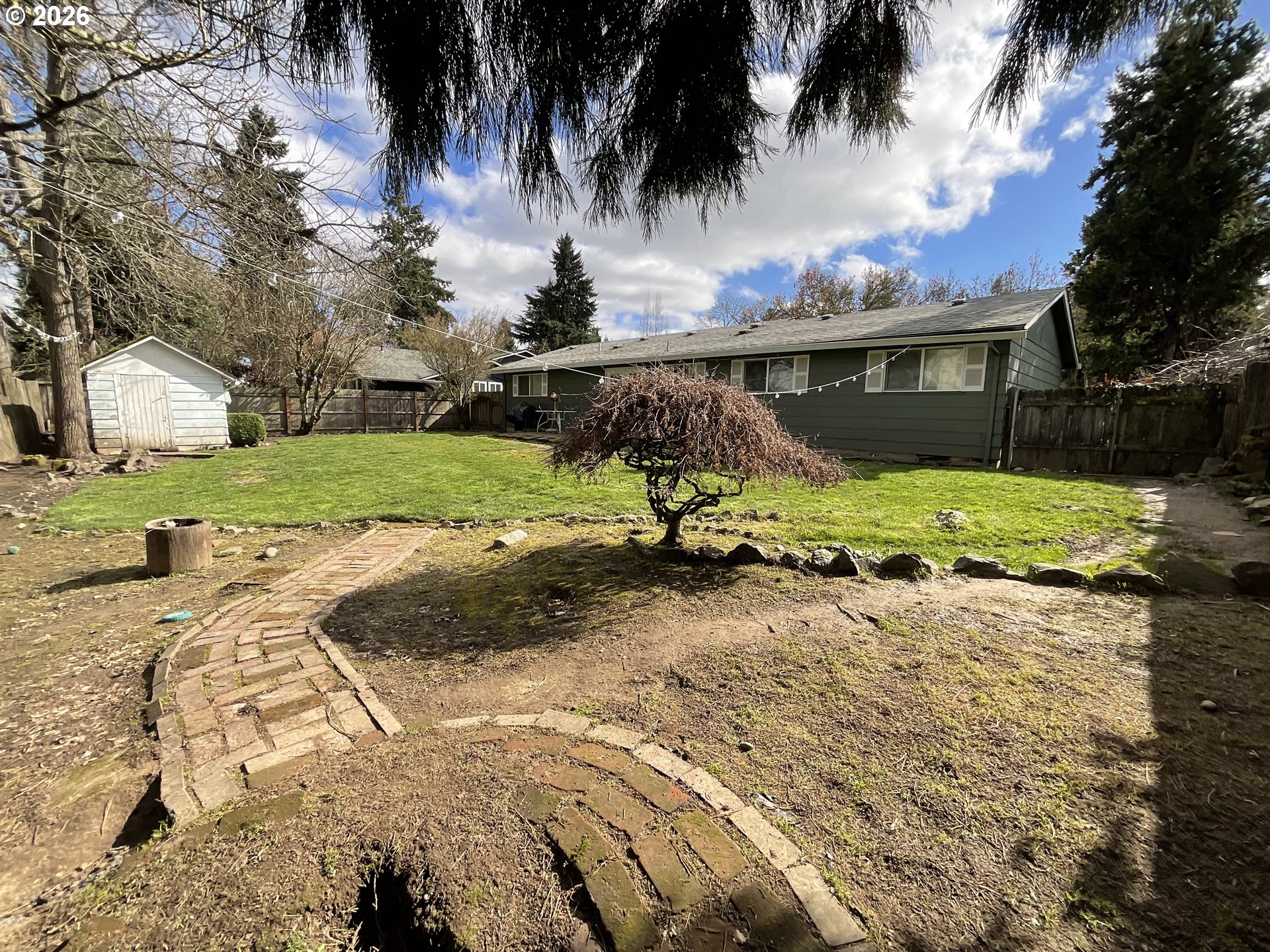 19305 Southwest York Street Beaverton, OR 97003 - Photo 28 of 34 a view of a backyard with a garden and palm tree