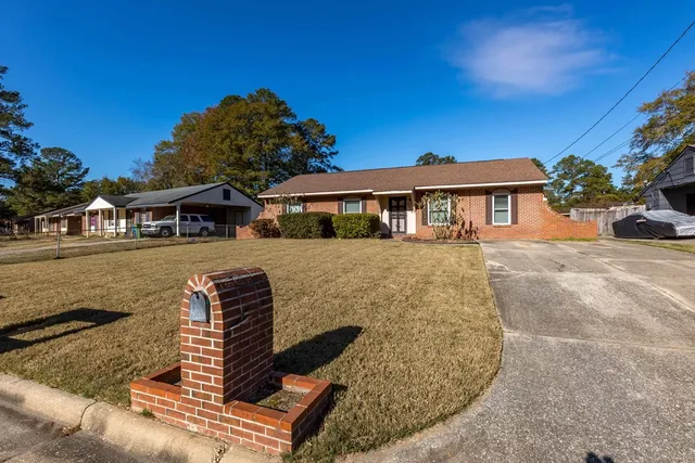 a front view of a house with a yard