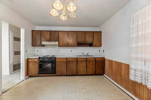 a kitchen with stainless steel appliances granite countertop a stove sink and cabinets