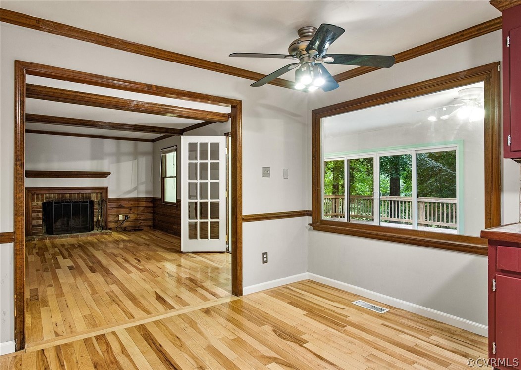13910 Barnes Spring Road Midlothian, VA 23112 - Photo 11 of 30 a view of a livingroom with a fireplace a ceiling fan and wooden floor