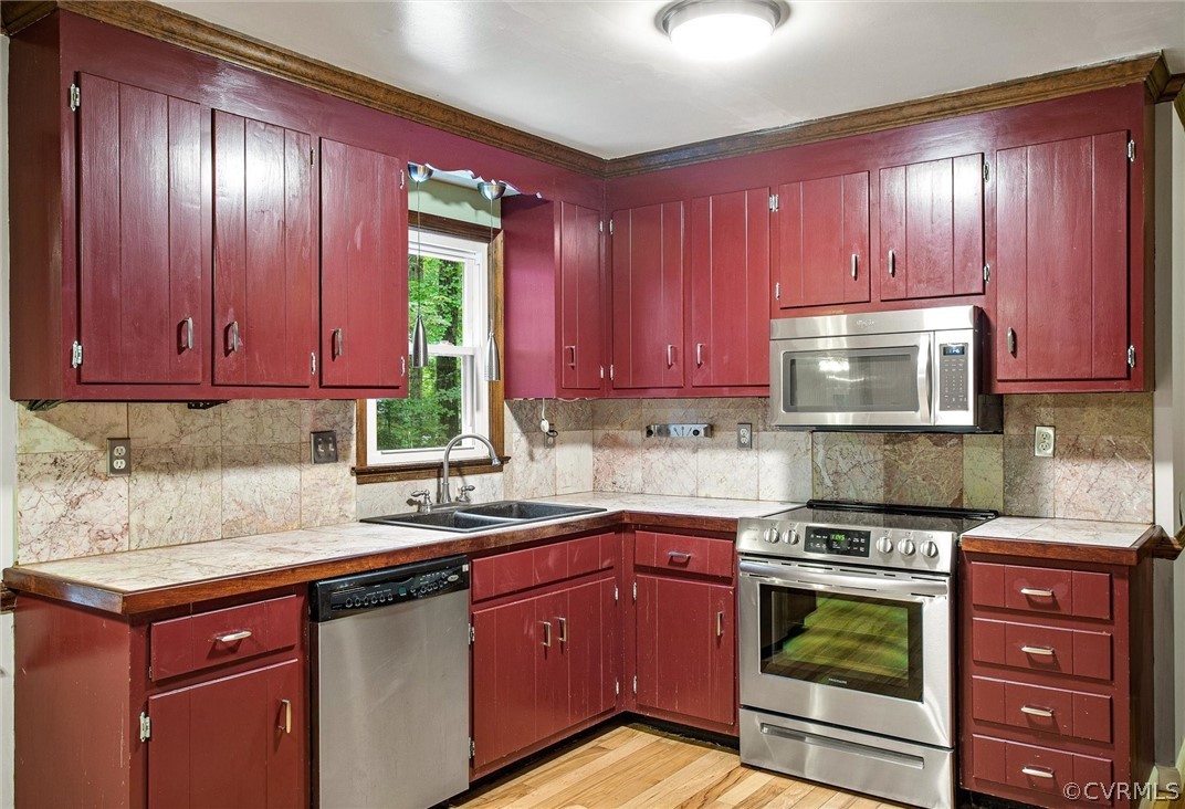 13910 Barnes Spring Road Midlothian, VA 23112 - Photo 13 of 30 a kitchen with stainless steel appliances granite countertop wooden cabinets and a stove top oven