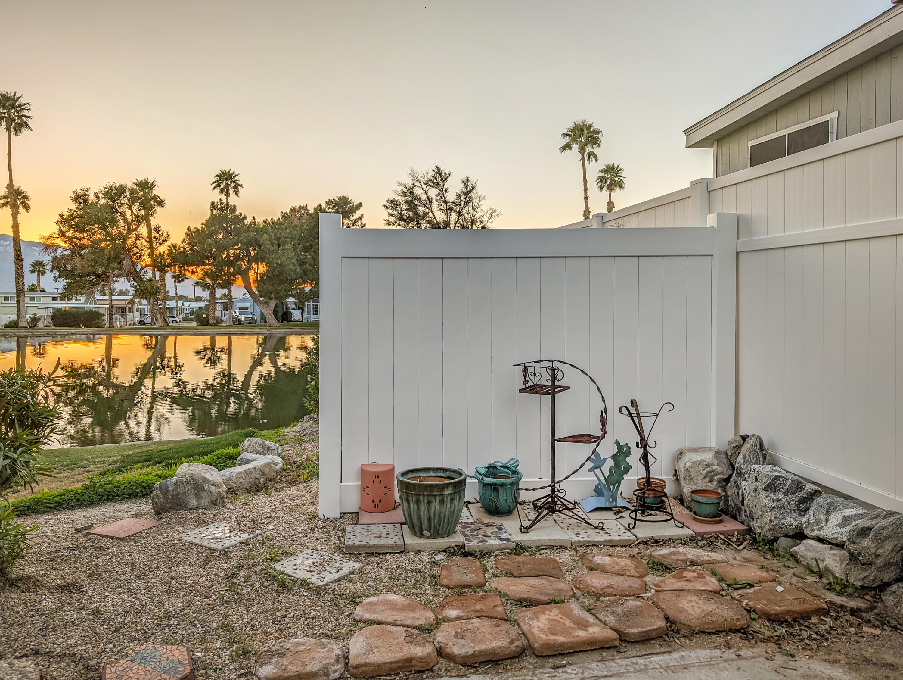 70200 Dillon Road, Unit 111 Desert Hot Springs, CA 92241 - Photo 18 of 25 a backyard of a house with table and chairs