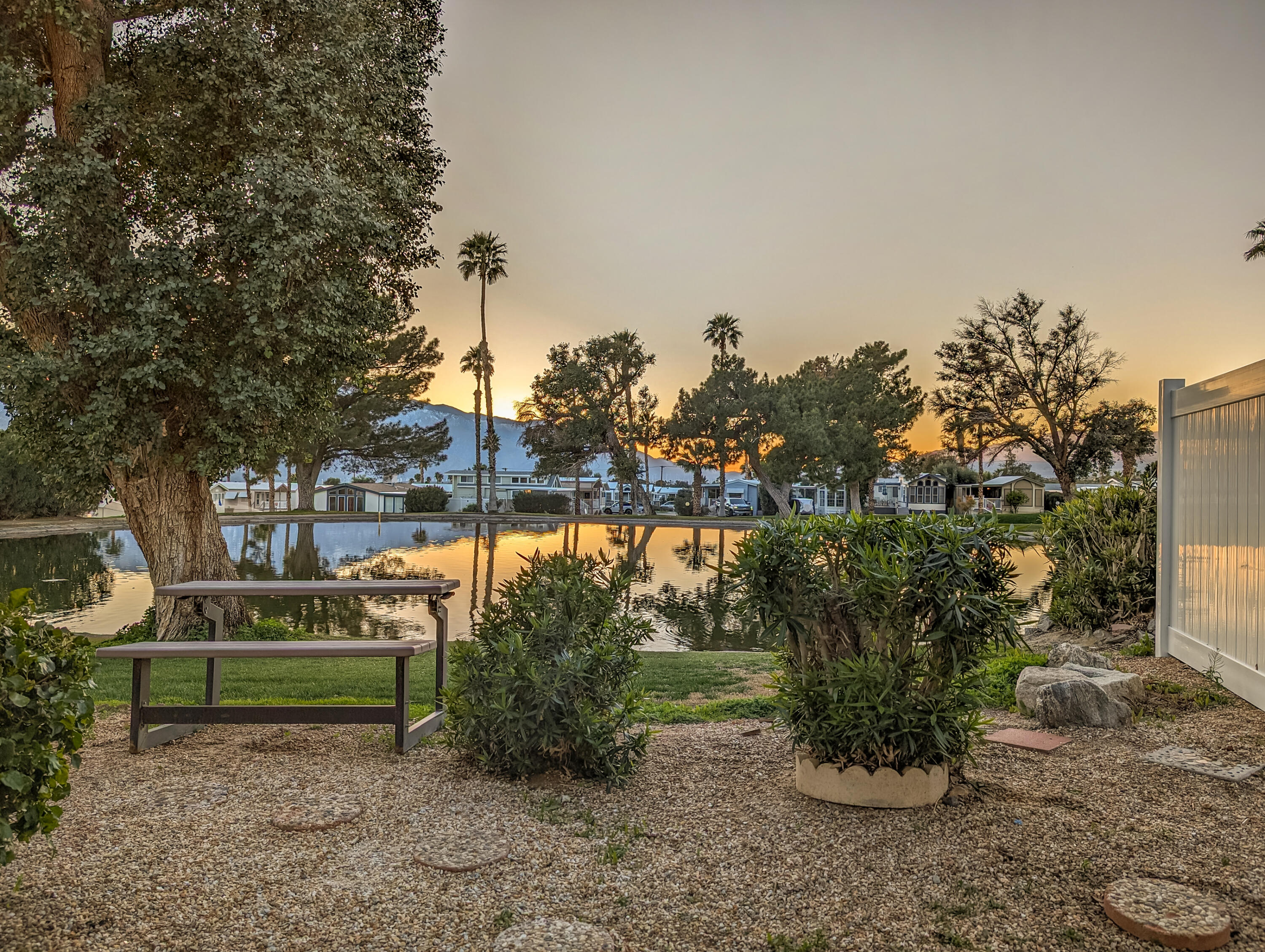 70200 Dillon Road, Unit 111 Desert Hot Springs, CA 92241 - Photo 19 of 25 a green field with trees in the background