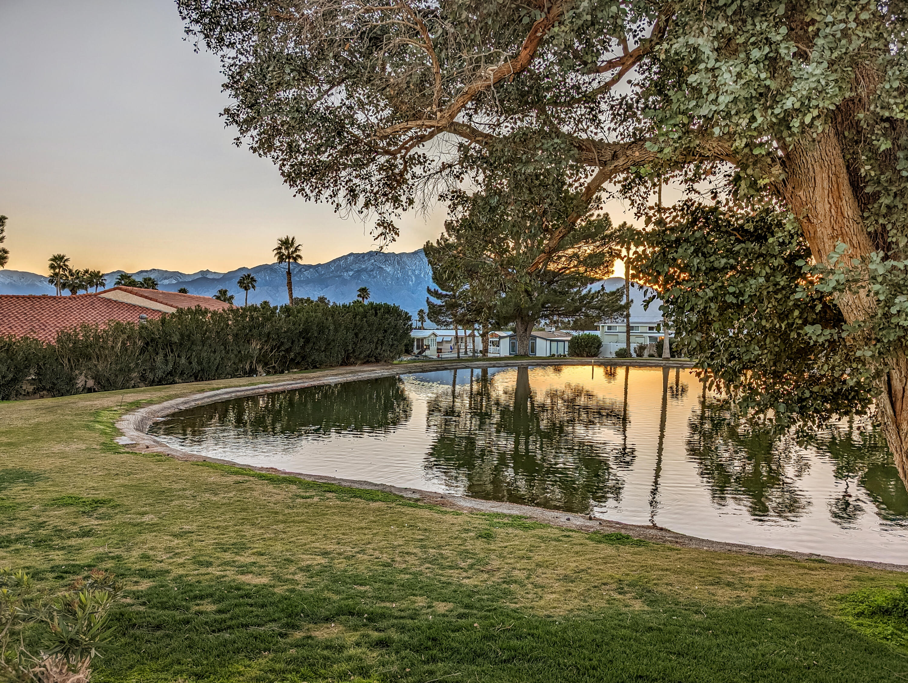 70200 Dillon Road, Unit 111 Desert Hot Springs, CA 92241 - Photo 20 of 25 a view of a lake with houses in background