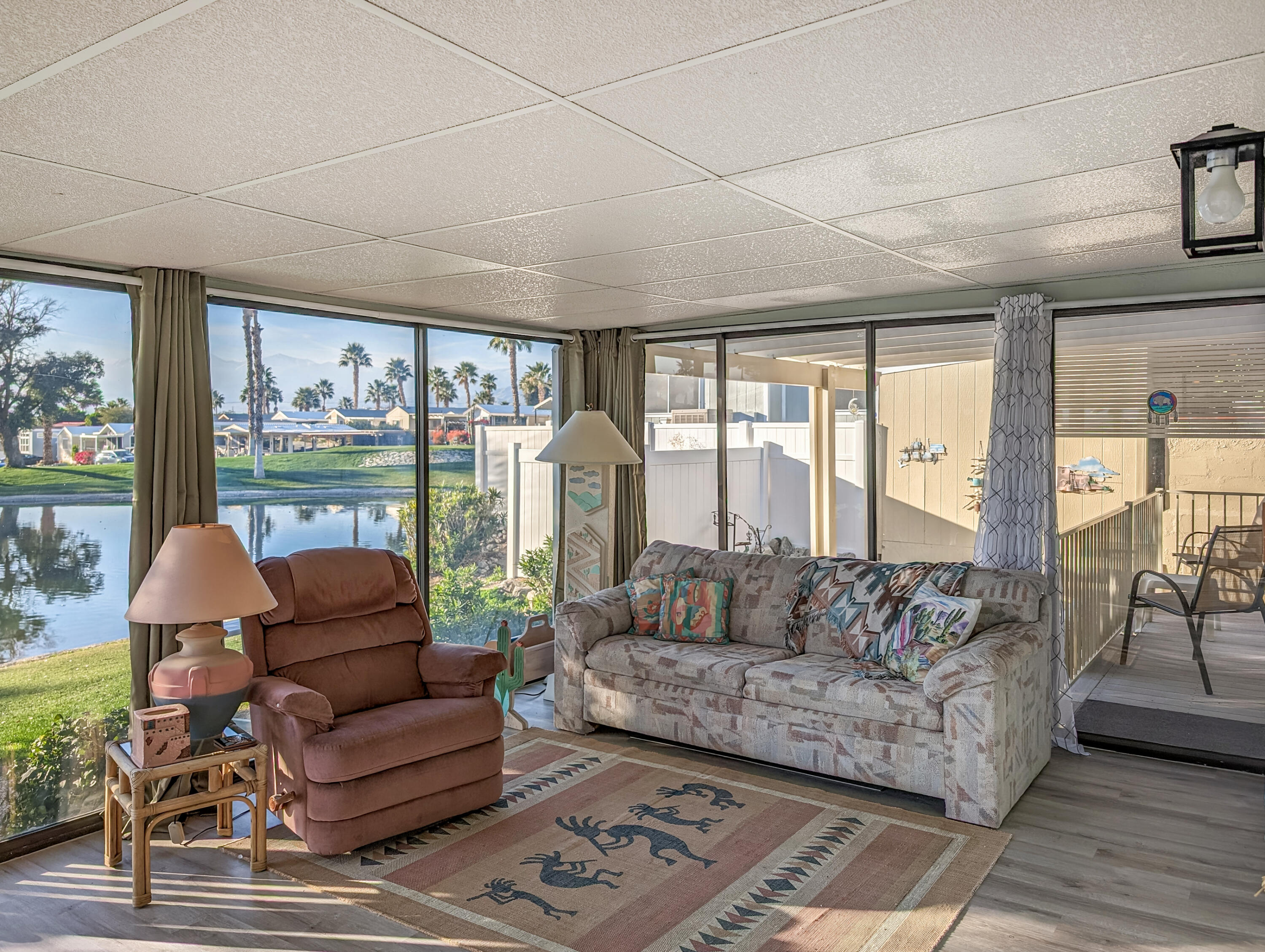 70200 Dillon Road, Unit 111 Desert Hot Springs, CA 92241 - Photo 2 of 25 a living room with furniture and a large window