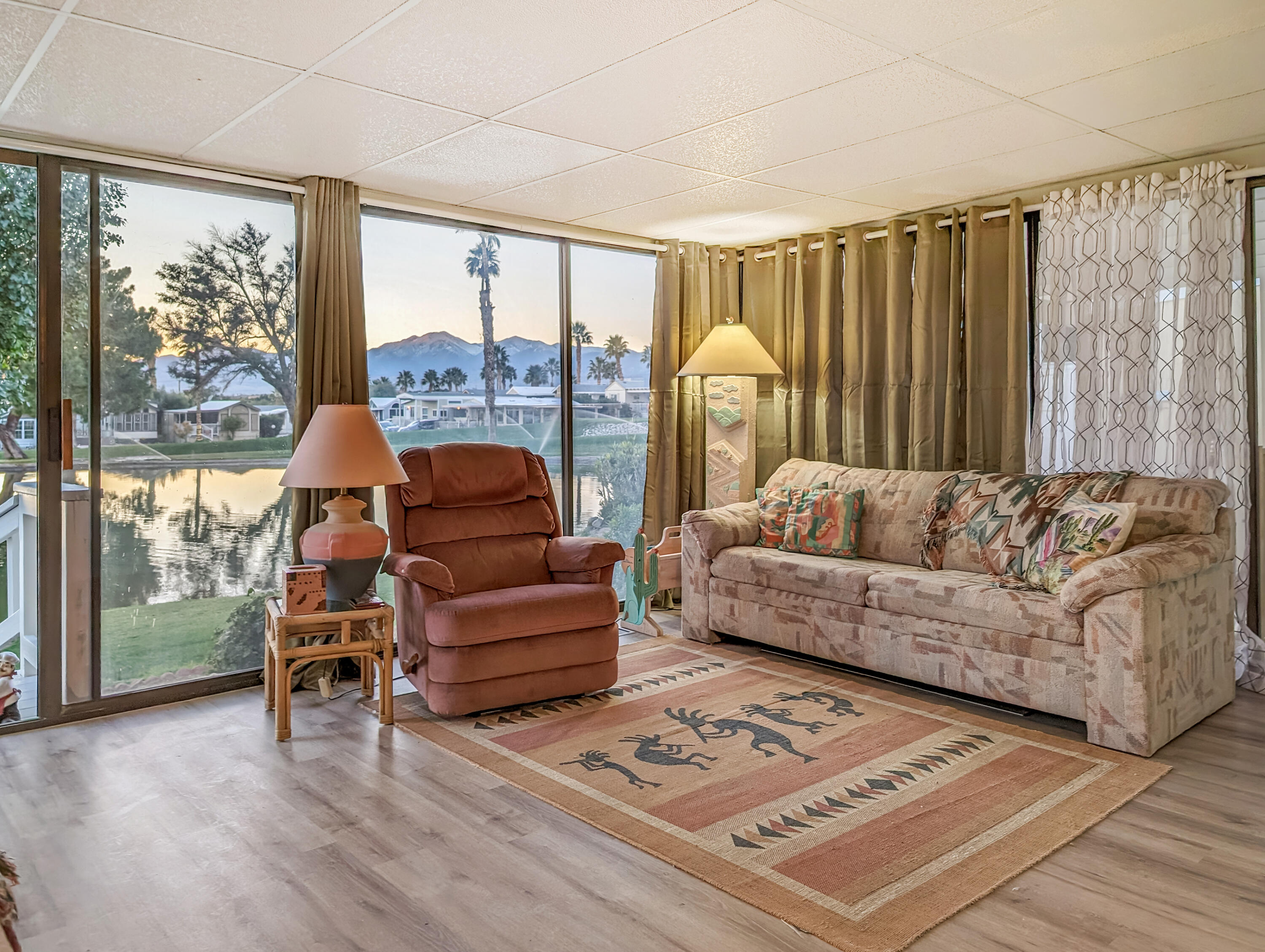 70200 Dillon Road, Unit 111 Desert Hot Springs, CA 92241 - Photo 21 of 25 a living room with furniture and a floor to ceiling window