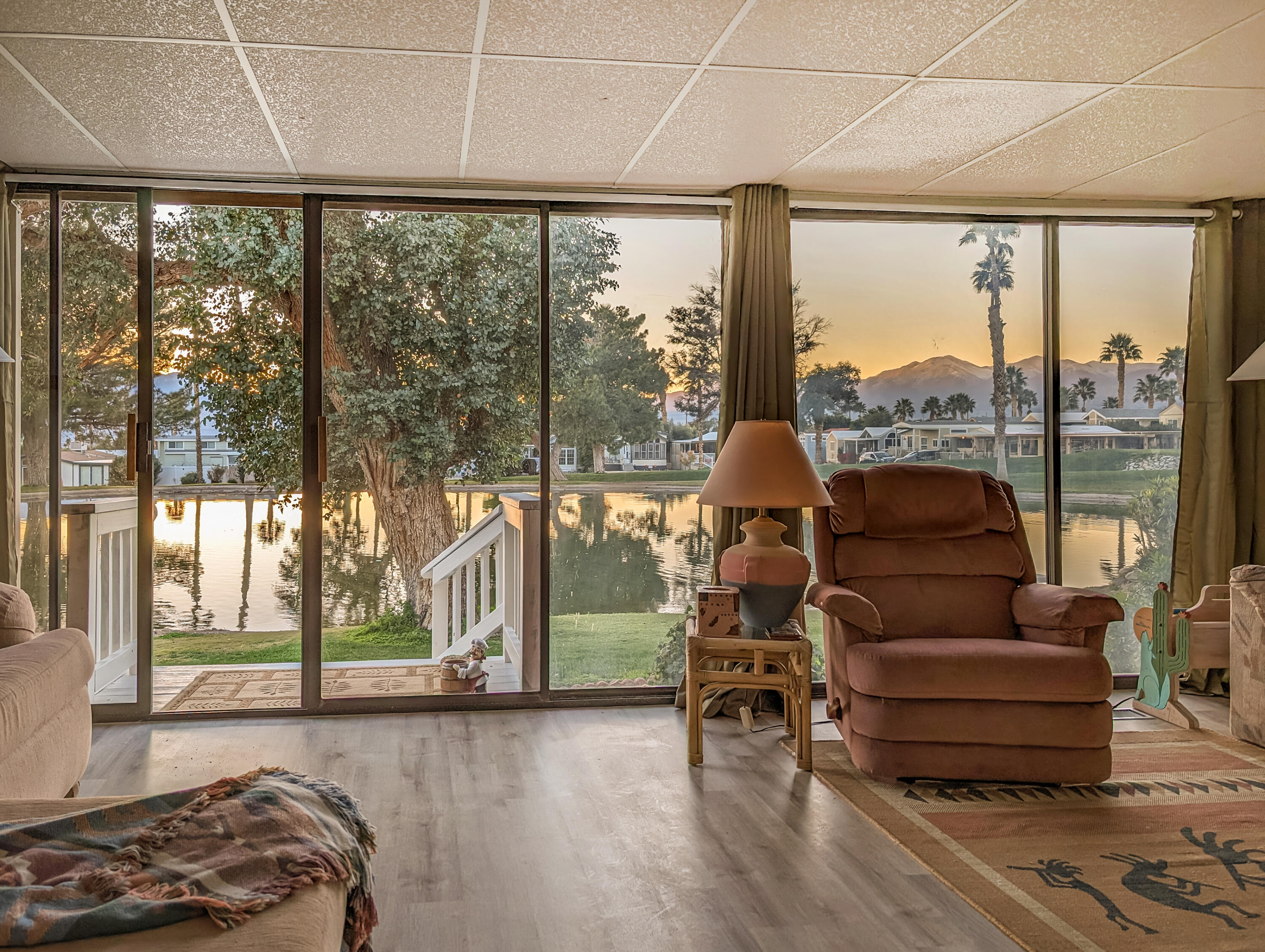 70200 Dillon Road, Unit 111 Desert Hot Springs, CA 92241 - Photo 22 of 25 a living room with furniture and a floor to ceiling window