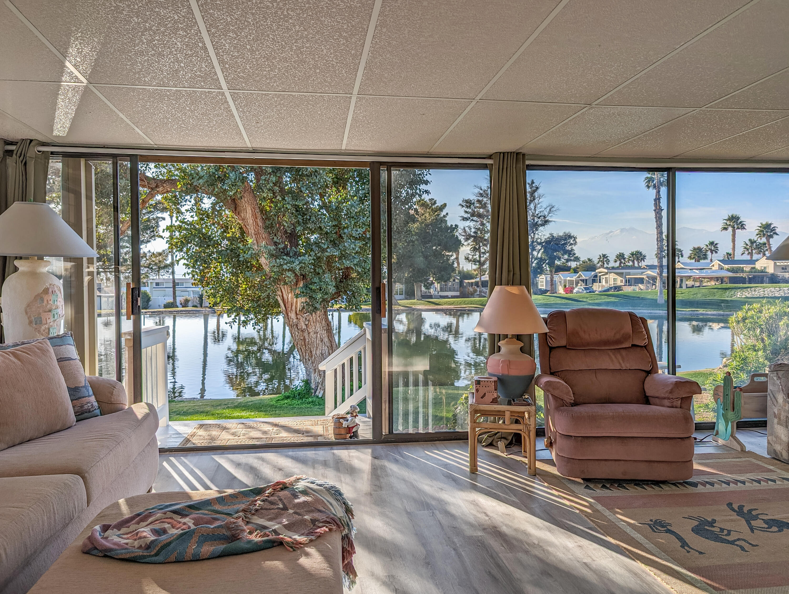 70200 Dillon Road, Unit 111 Desert Hot Springs, CA 92241 - Photo 4 of 25 a living room with furniture and a floor to ceiling window