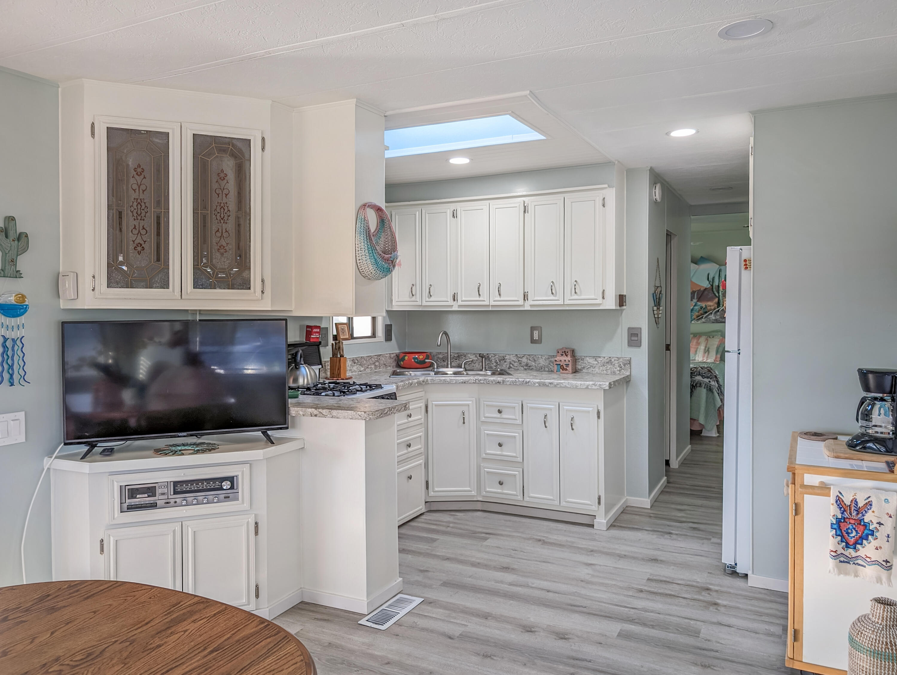 70200 Dillon Road, Unit 111 Desert Hot Springs, CA 92241 - Photo 7 of 25 a kitchen with a stove microwave and cabinets