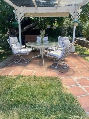 a view of a backyard with plants and a patio