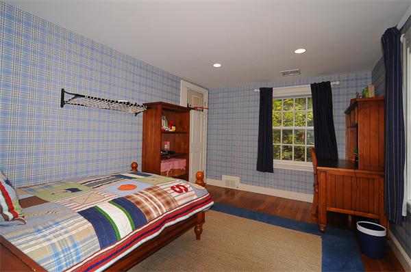 36 Pinecroft Road Weston, MA 02493 - Photo 15 of 19 a bedroom with a bed and wooden floor