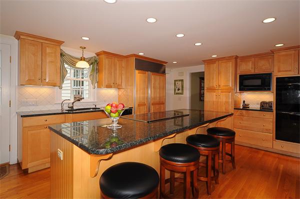 36 Pinecroft Road Weston, MA 02493 - Photo 6 of 19 a kitchen with stainless steel appliances granite countertop a sink a stove and a refrigerator