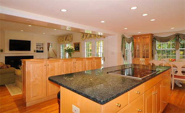 36 Pinecroft Road Weston, MA 02493 - Photo 8 of 19 a kitchen with stainless steel appliances granite countertop a sink a counter space and a view of living room