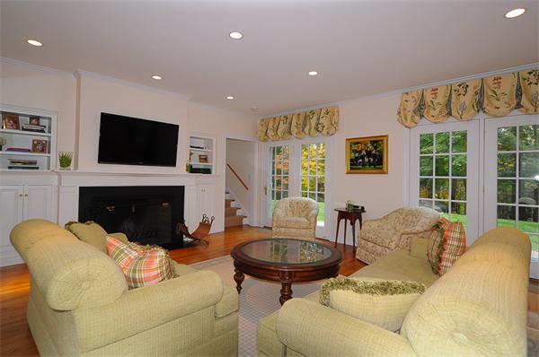 36 Pinecroft Road Weston, MA 02493 - Photo 9 of 19 a living room with furniture a fireplace and a flat screen tv