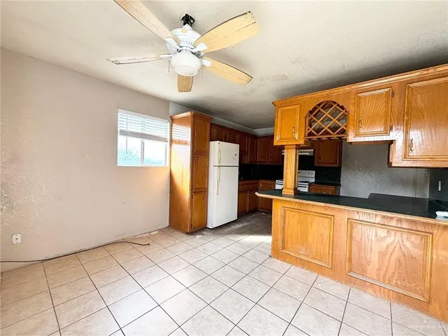 a kitchen with stainless steel appliances granite countertop a sink and a refrigerator