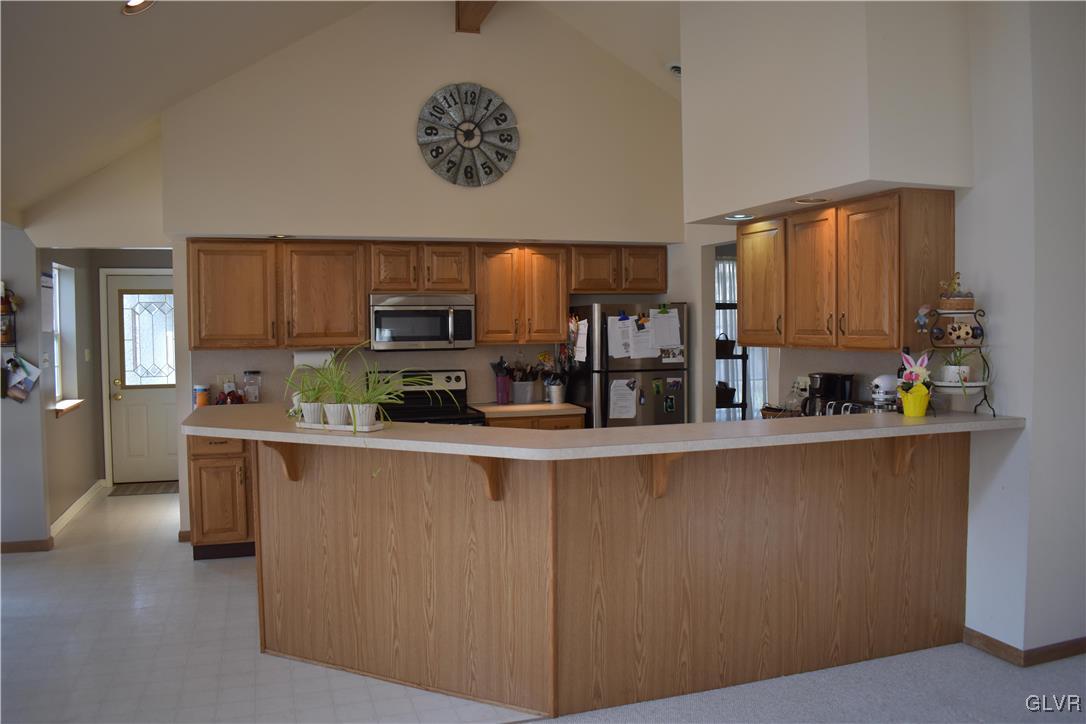 5869 Spangler Road Nazareth, PA 18064 - Photo 13 of 33 a kitchen with stainless steel appliances granite countertop a refrigerator a stove top oven a sink and dishwasher