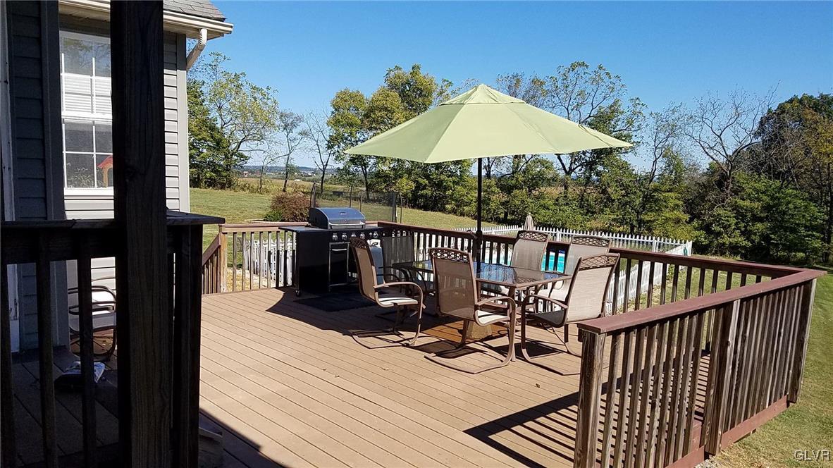 5869 Spangler Road Nazareth, PA 18064 - Photo 2 of 33 a view of a balcony with chair and umbrella