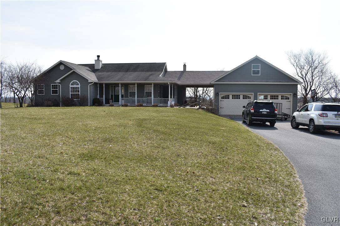 5869 Spangler Road Nazareth, PA 18064 - Photo 4 of 33 a front view of a house with a garden and yard