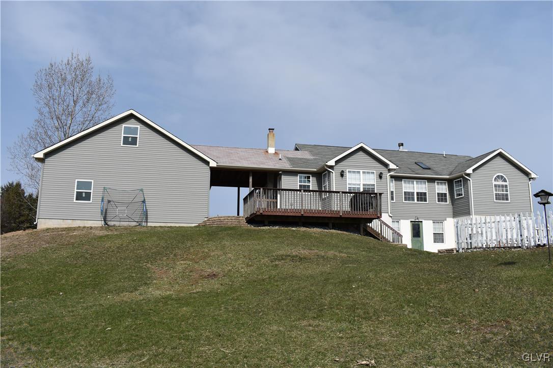 5869 Spangler Road Nazareth, PA 18064 - Photo 5 of 33 a front view of a house with a yard