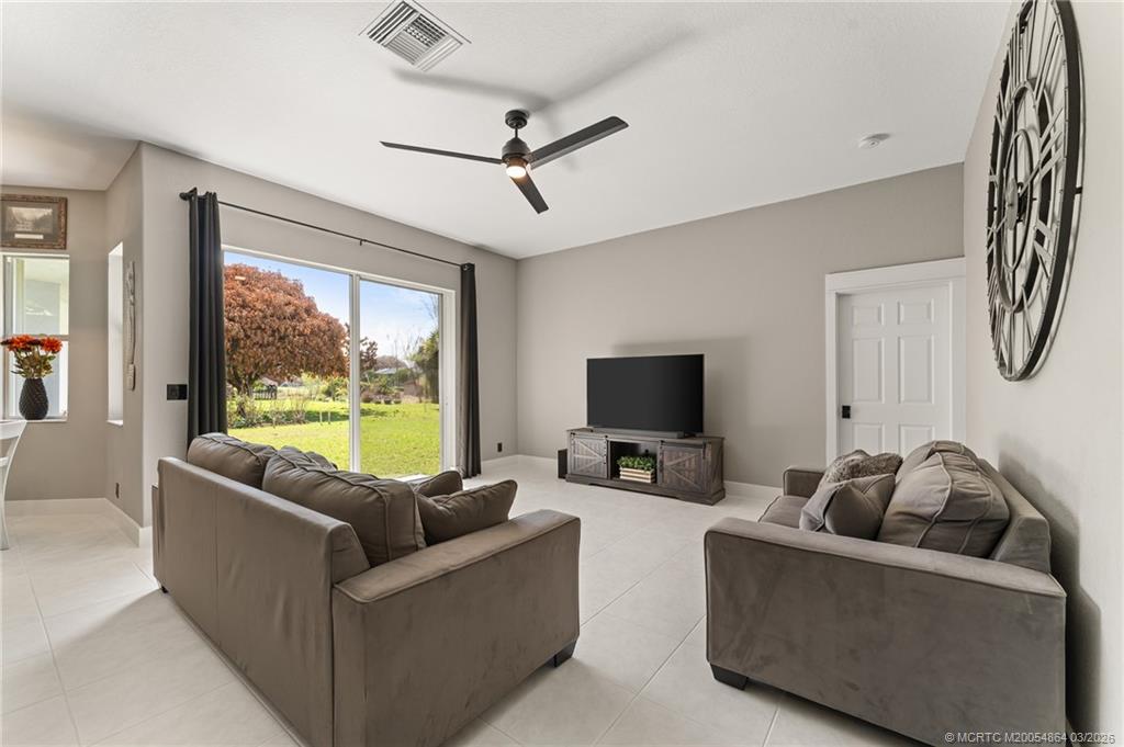2072 Southeast Hanford Road Port St. Lucie, FL 34952 - Photo 15 of 58 a living room with furniture and a flat screen tv