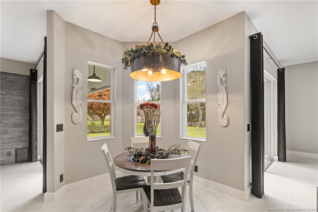 2072 Southeast Hanford Road Port St. Lucie, FL 34952 - Photo 16 of 58 a dining room with furniture and window