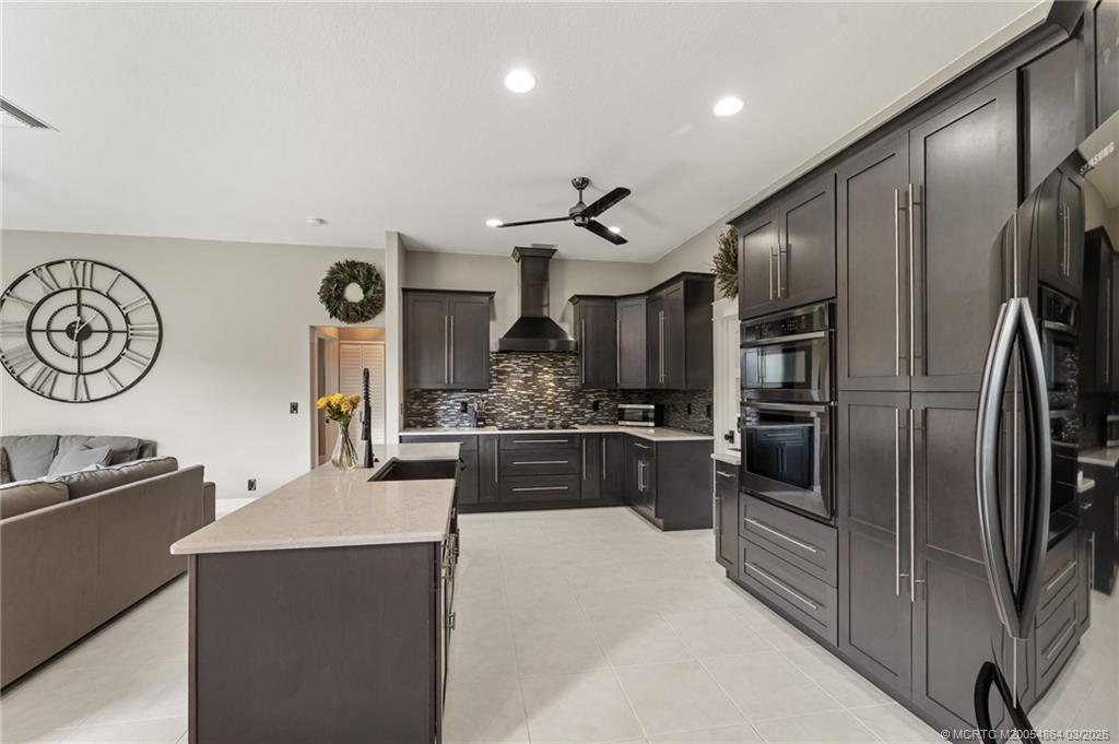 2072 Southeast Hanford Road Port St. Lucie, FL 34952 - Photo 17 of 58 a kitchen with stainless steel appliances granite countertop a refrigerator a oven a stove and a sink