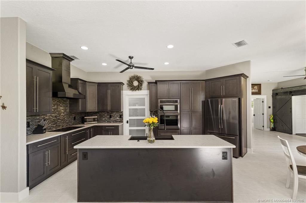 2072 Southeast Hanford Road Port St. Lucie, FL 34952 - Photo 18 of 58 a kitchen with stainless steel appliances a refrigerator and a stove